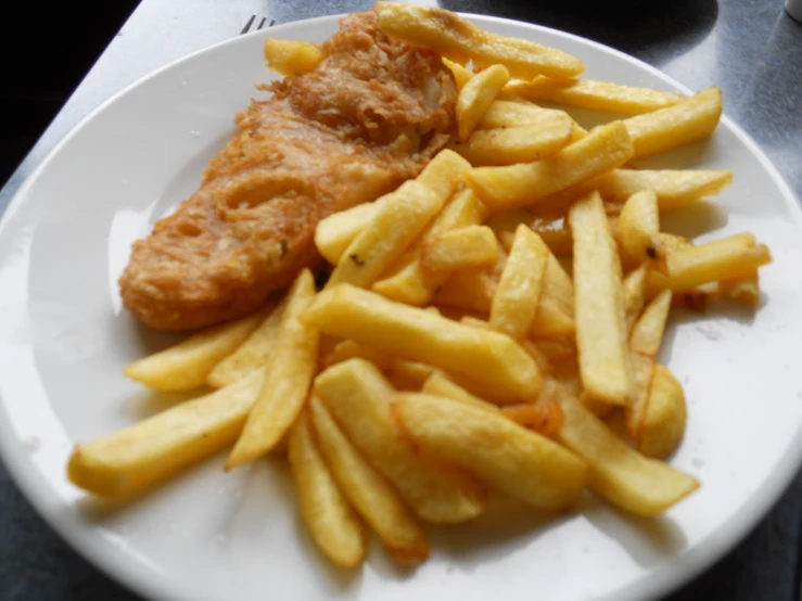 a fish and fries on a plate on a table