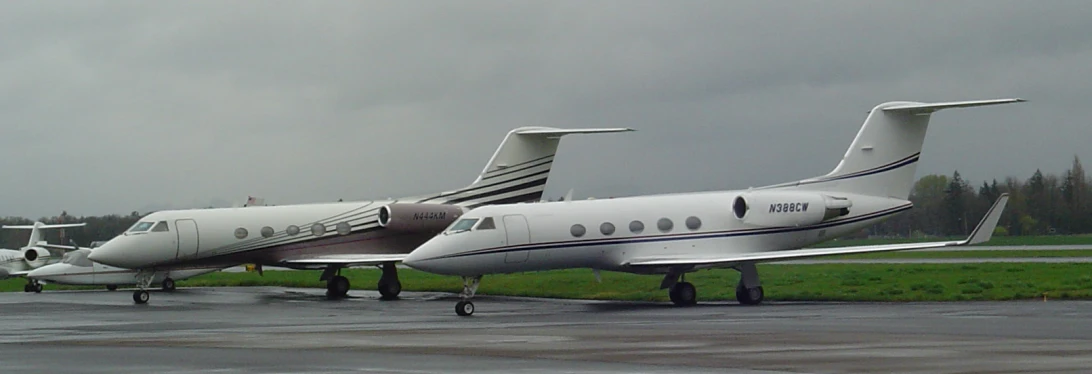 three airplanes sitting on top of an airport runway