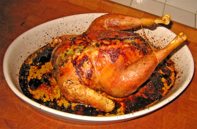 a turkey with a side of sauce in a bowl
