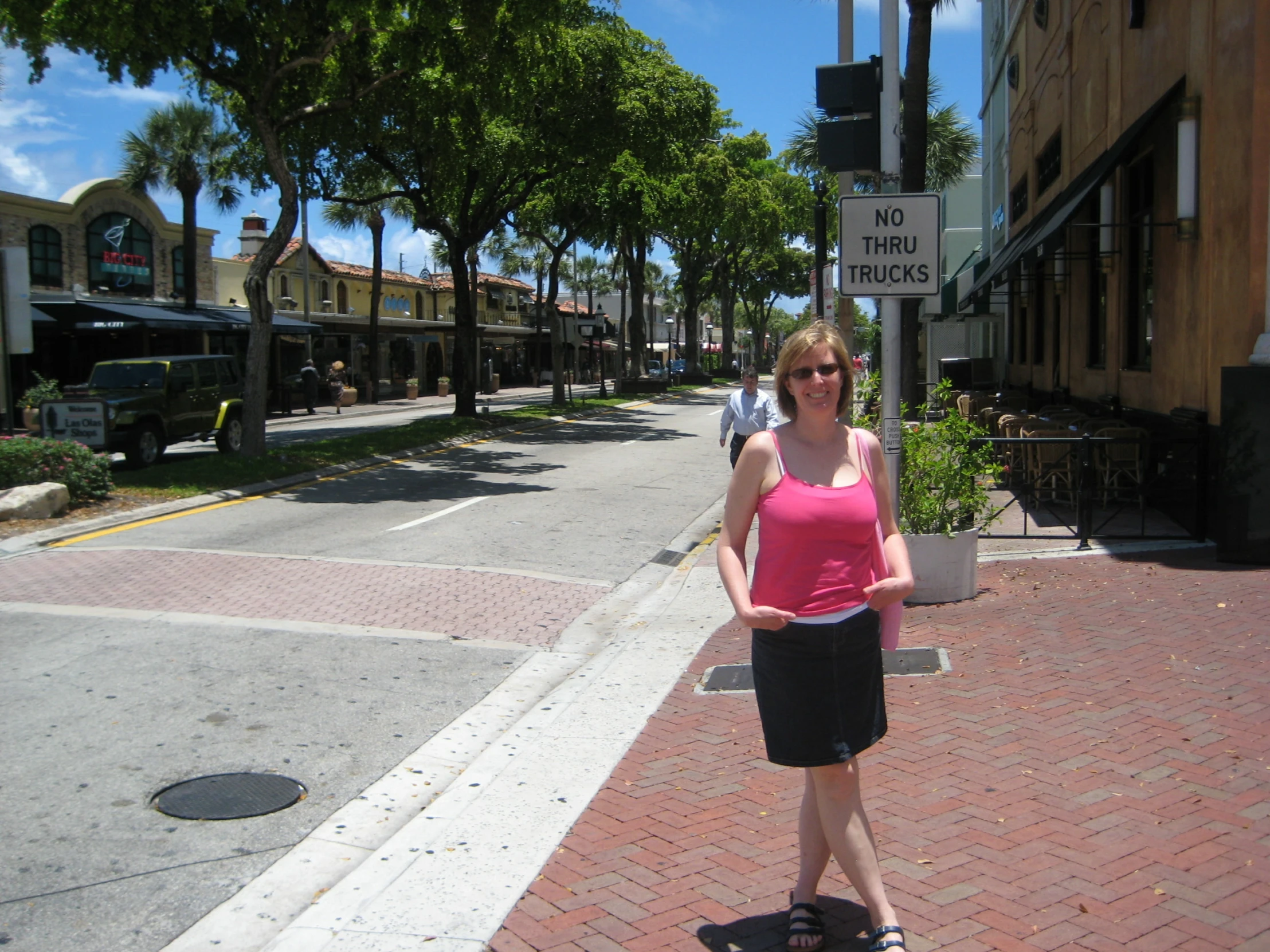 woman standing on a skateboard in the middle of the street