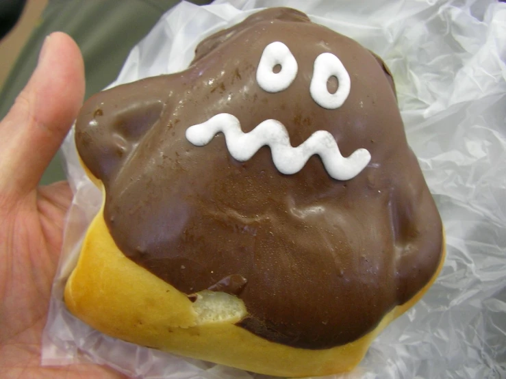 chocolate covered pastry with spooky eyes and white toppings