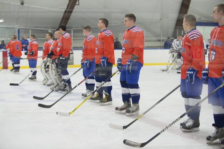 men standing in line wearing red and blue uniforms