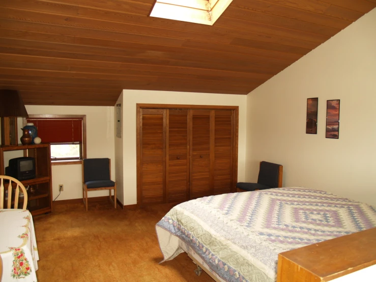 a bedroom with wood floors and bed in it