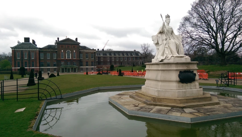 the fountain in front of a large brick building