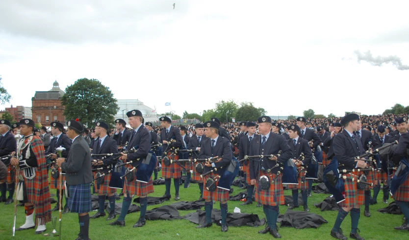 an image of a band playing pipes on the grass