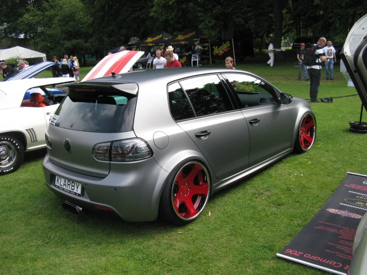 a car is parked on the grass by others