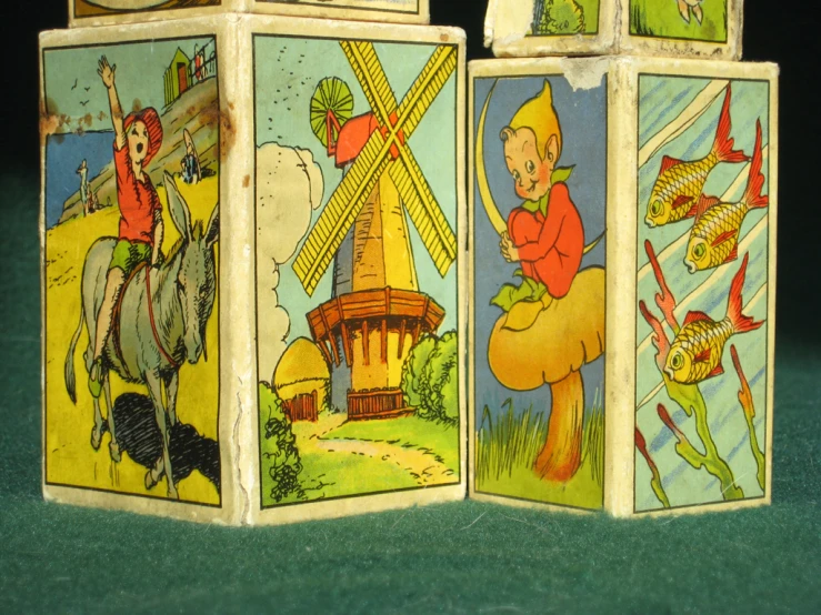four cartoon wooden blocks with one showing a man, the other showing an elephant