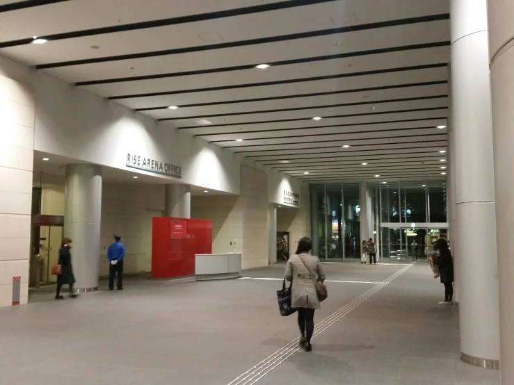 a man is walking in a very large building