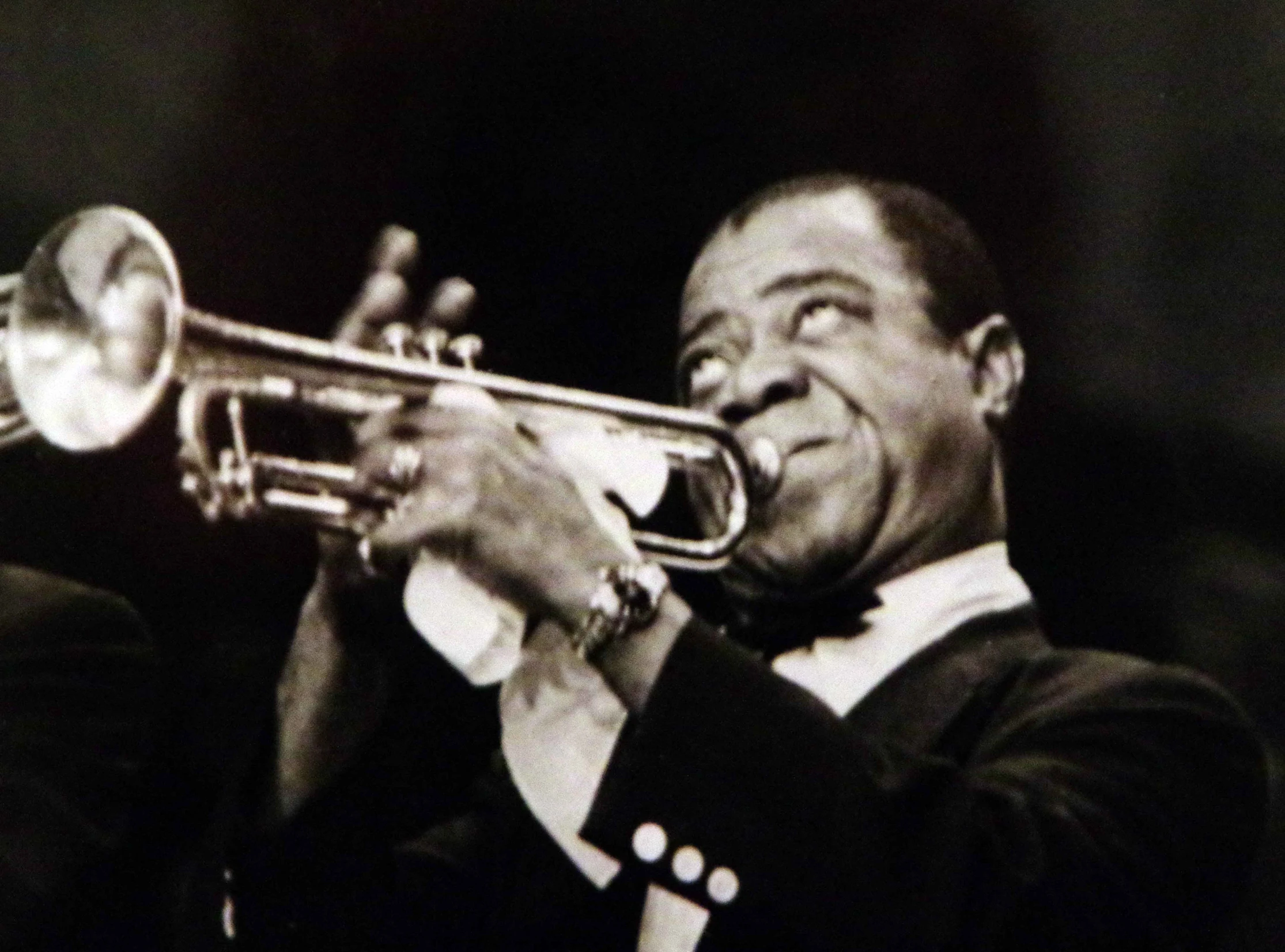 a vintage picture shows a man holding a trumpet