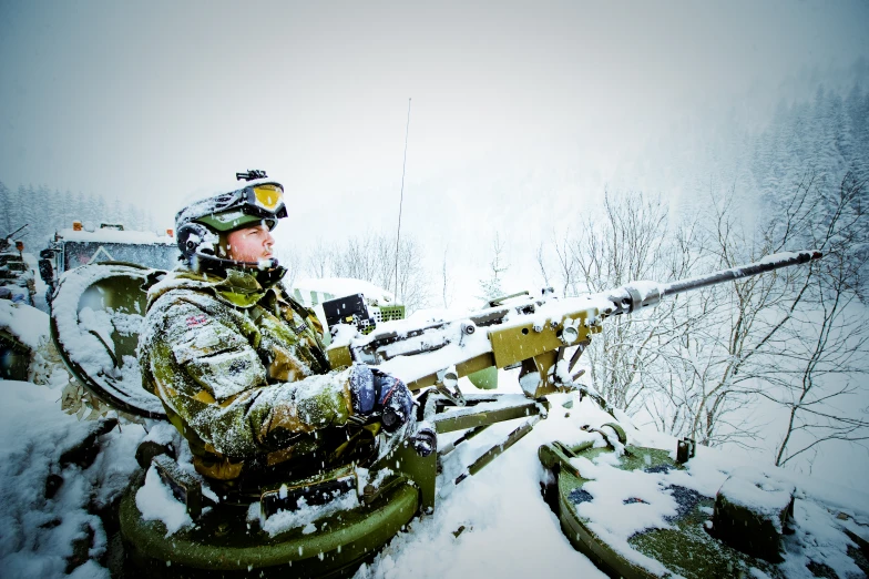 a person with a hunting rifle in the snow