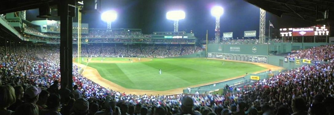 an audience at a baseball game is watching a pitch