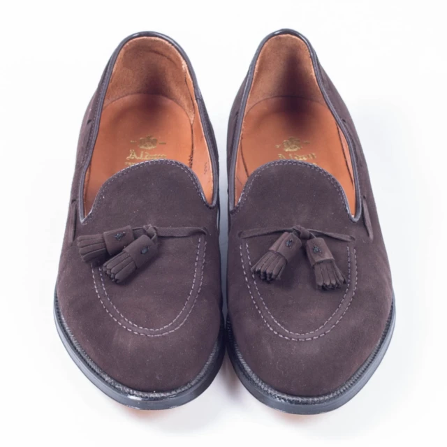 a pair of brown shoes that are sitting on the floor