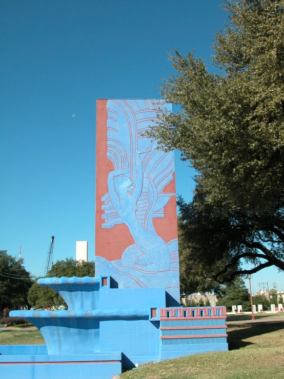 a red and blue building with a clock tower in the background