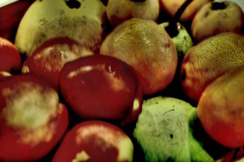 the large group of red apples is in a white bowl