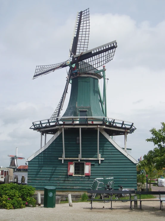 a building with a big windmill and a picnic table