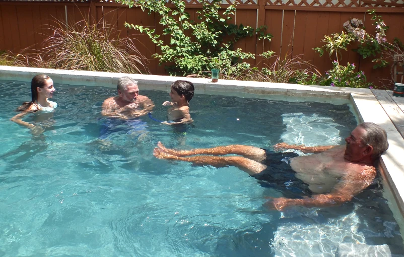 a group of people in the pool playing soccer