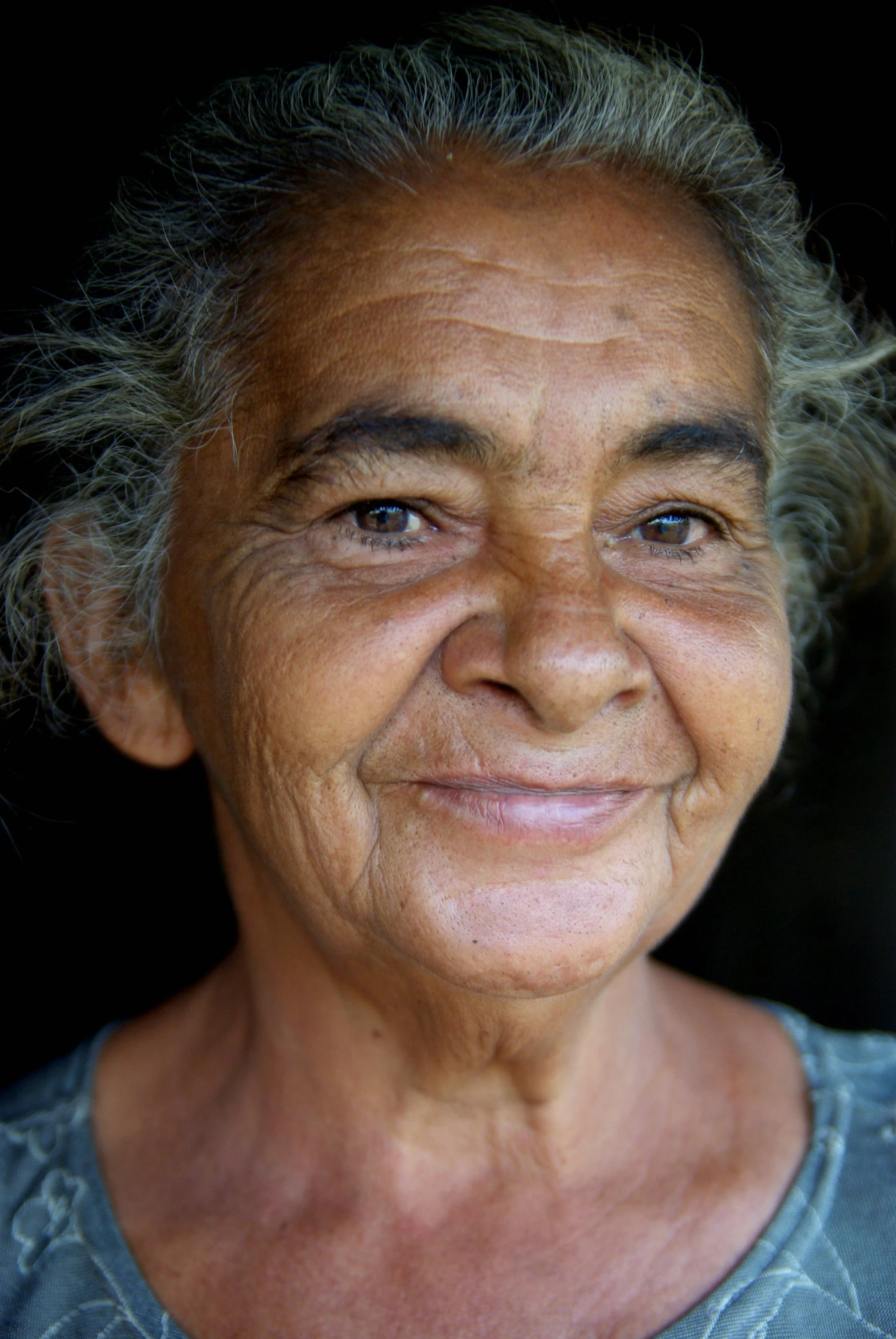 an older woman has wrinkles and a smile