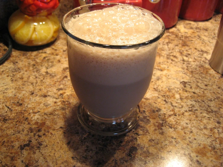 a glass filled with milk and other drinks