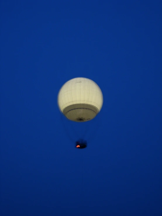 an empty  air balloon rising high into the sky