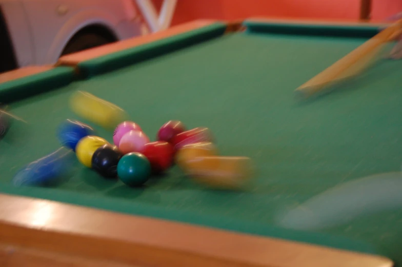 there are three different colored pool balls on the table