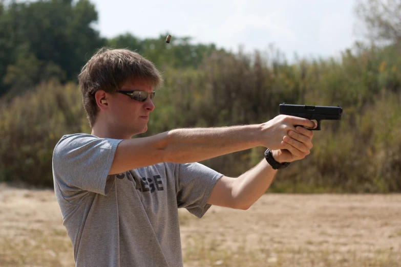 a man aims his gun at the viewer