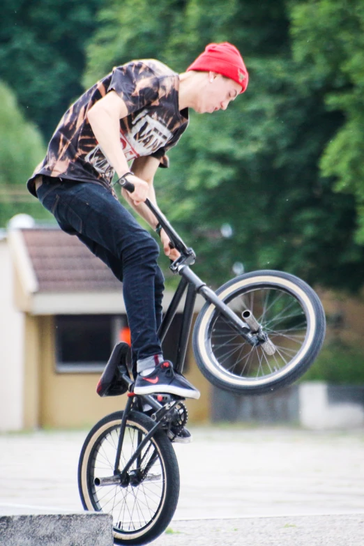 boy riding a bike while performing tricks on a ramp