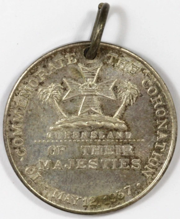 an old coin with a silver medallion with a white background