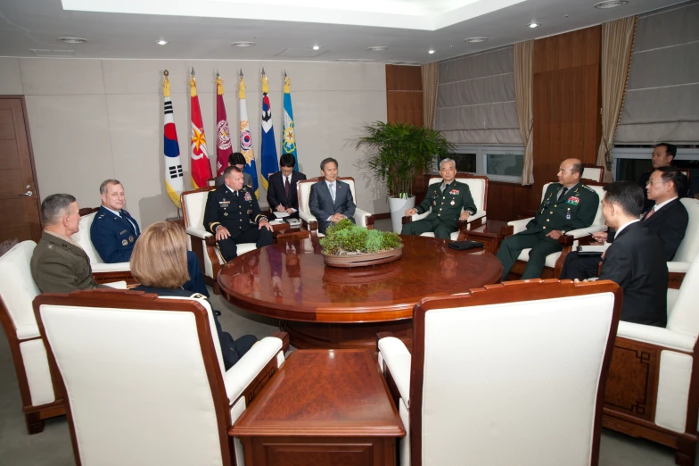 five people seated at a table in a meeting room