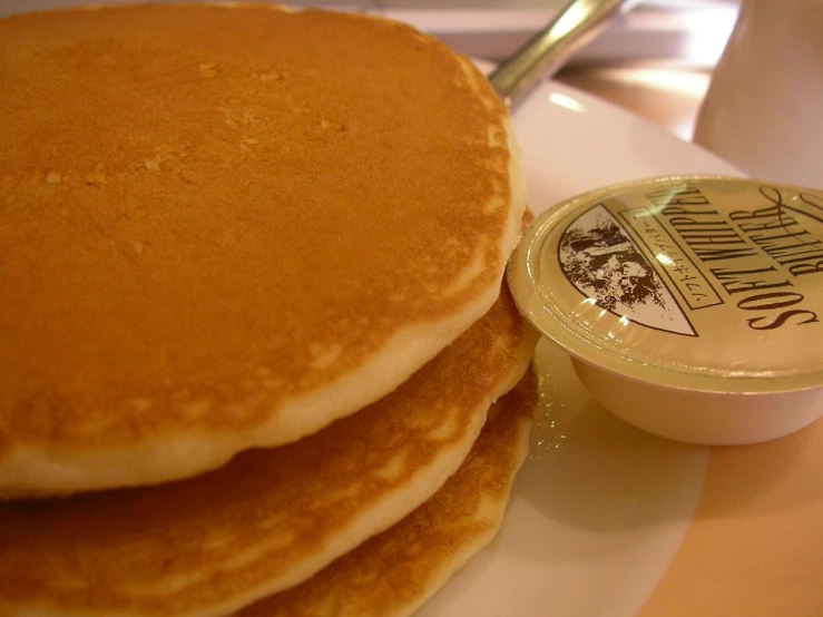 three pancakes with er sitting on a plate