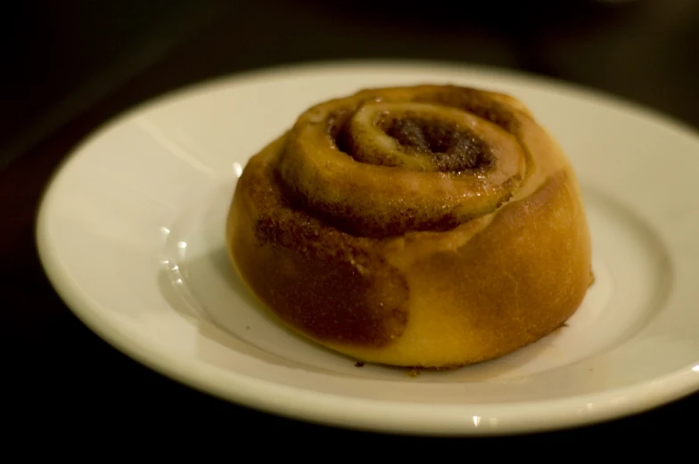 a cinnamon roll on a plate on a table