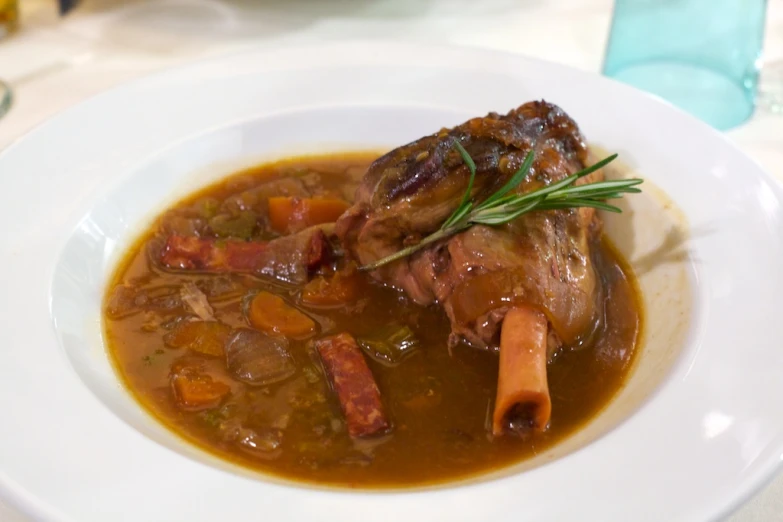 a white bowl filled with soup and a garnish