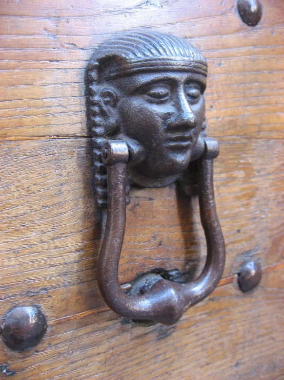 a decorative door handle on a wooden background