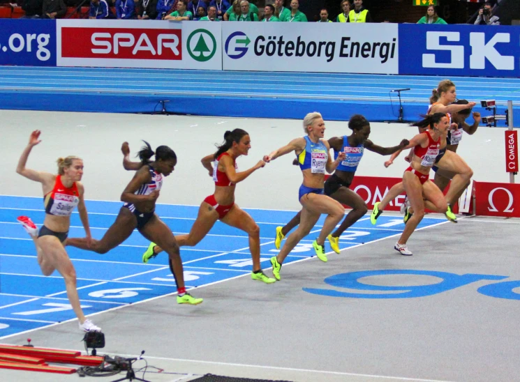 athletes compete in a race on an indoor track