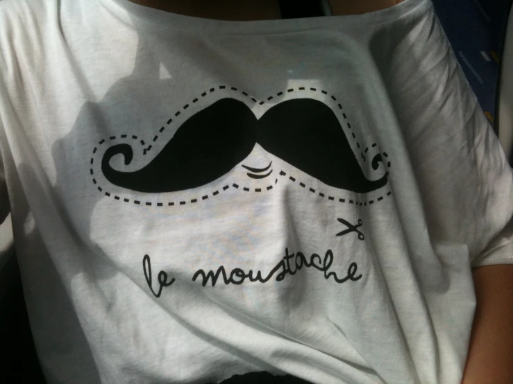 a person's t - shirt with a black mustache on it