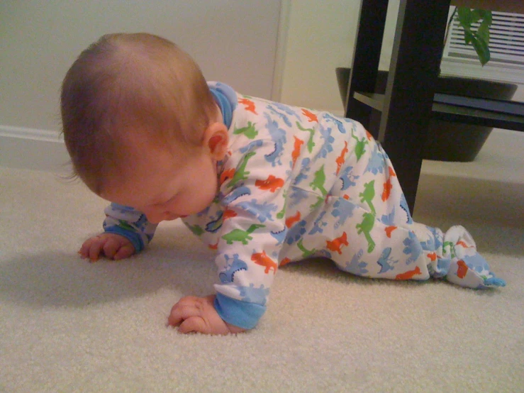 a baby is crawling on the floor