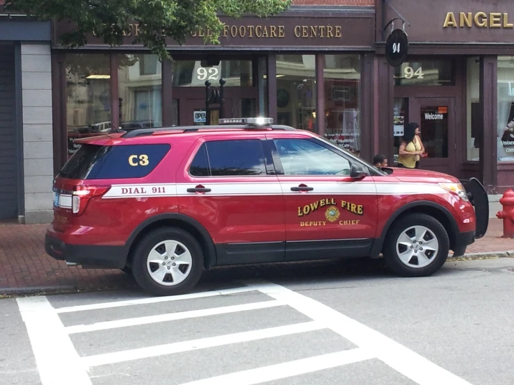 a red police car parked by the side of the street