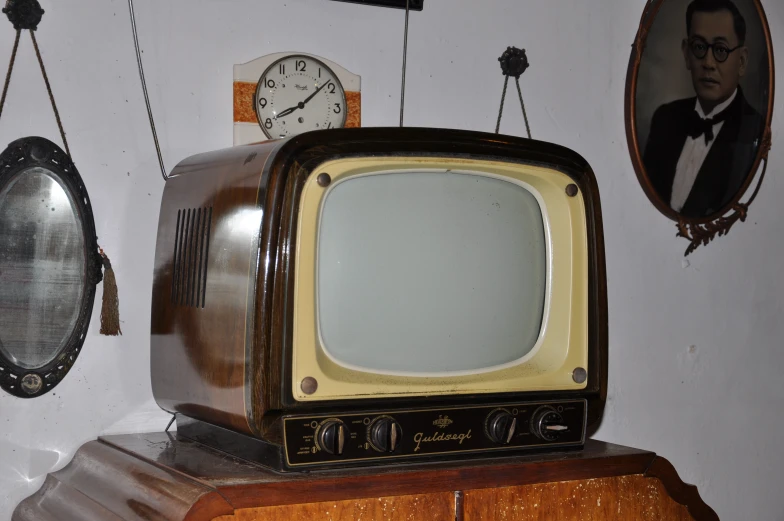 an old television on top of a wooden table