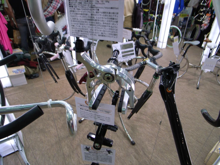 several bicycles and mirrors hanging from racks on display