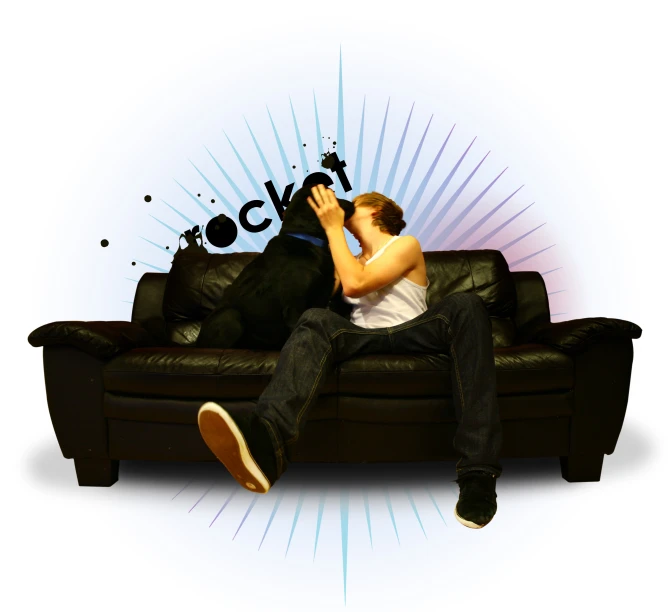 a man laying on top of a black couch