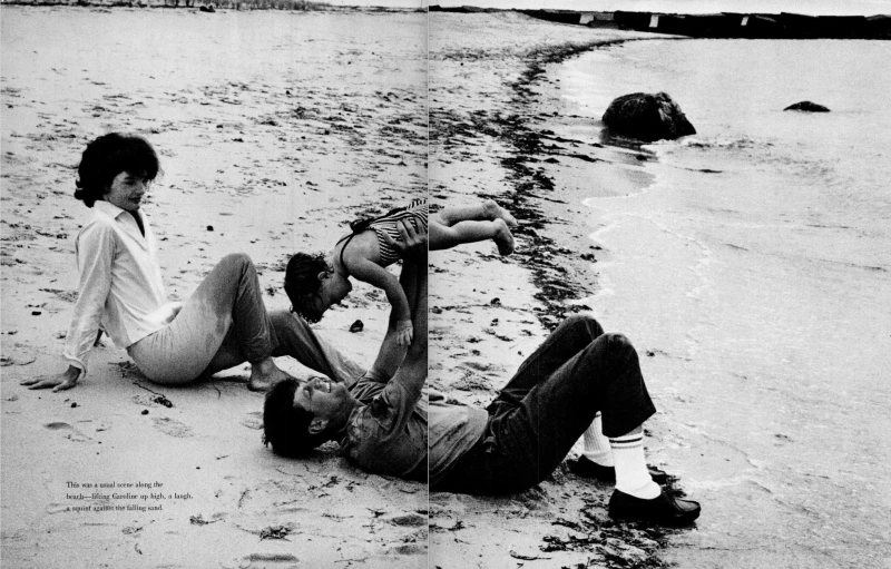 two guys laying on the sand with their backs in a pool of water