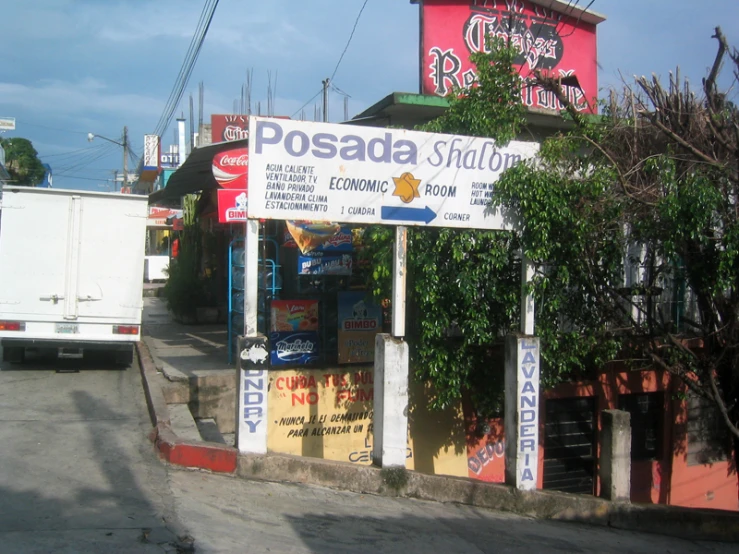 the road is paved and lined with many signs