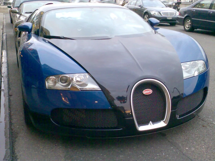 a blue car sitting on the side of a road