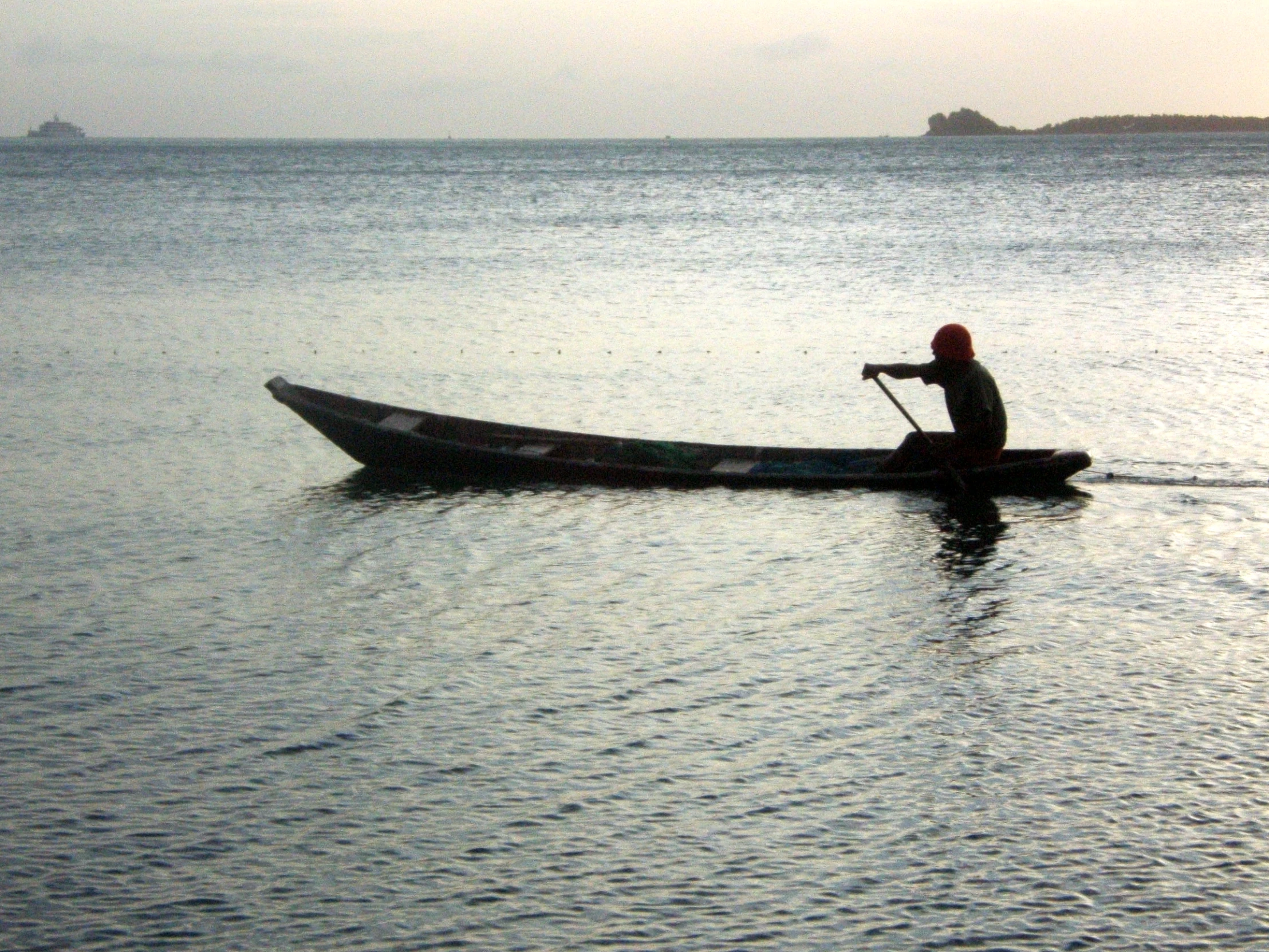 a man rows a canoe through the water