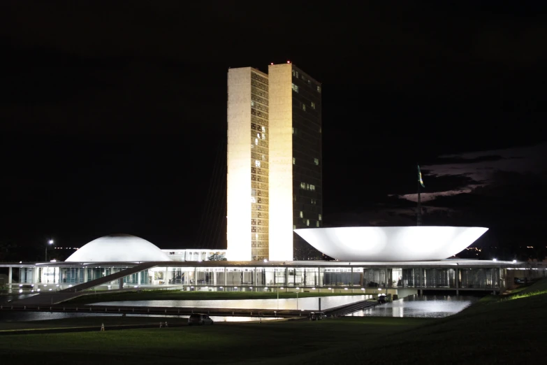 a building with a white roof is illuminated in the dark