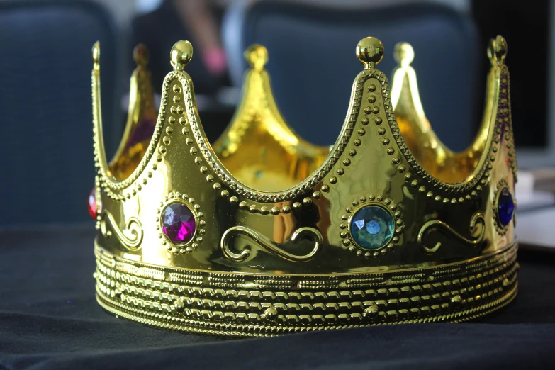 a gold crown with three jewels on it