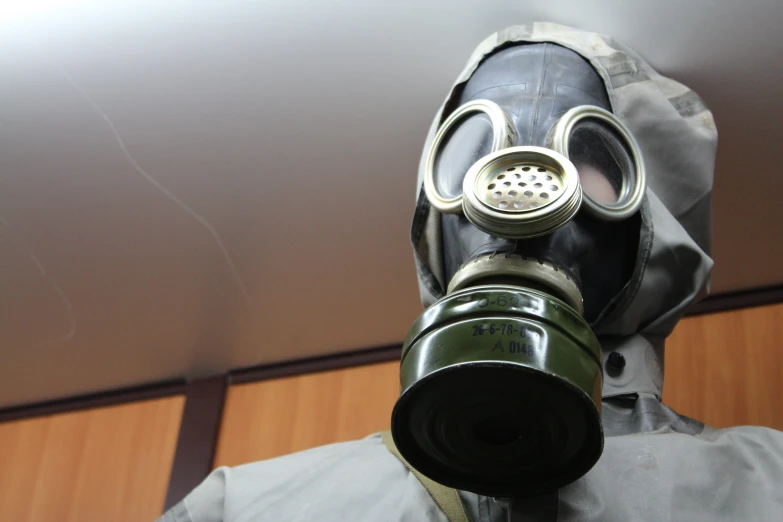 a man wearing a gas mask has brown hair