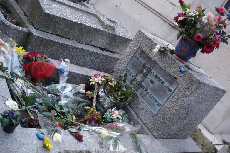 the monument has a bunch of flowers left on it