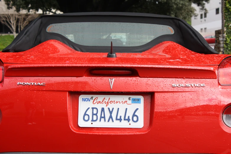 the back view of a red convertible