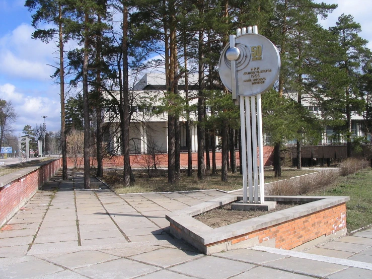 a monument sits on a brick walkway in the middle of a brick park