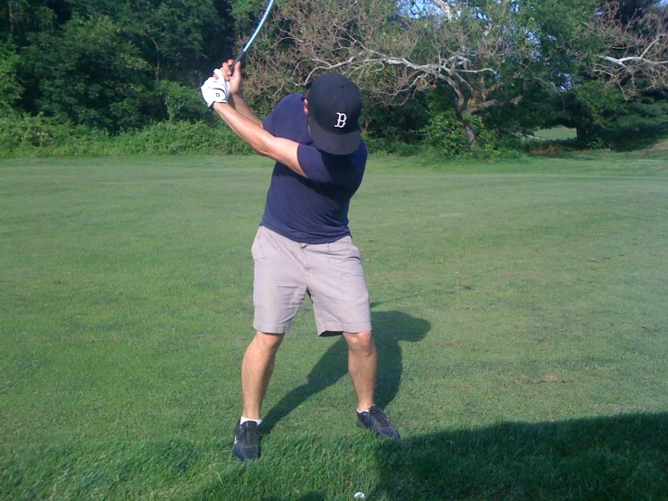 a man hits his tee ball into the air